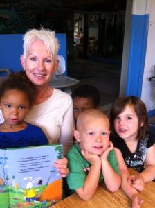 Volunteer Reading Pal Erika Bauserman reads a Dora the Explorer book to her weekly group of preschoolers at Brandts Child Care in St. Augustine.  